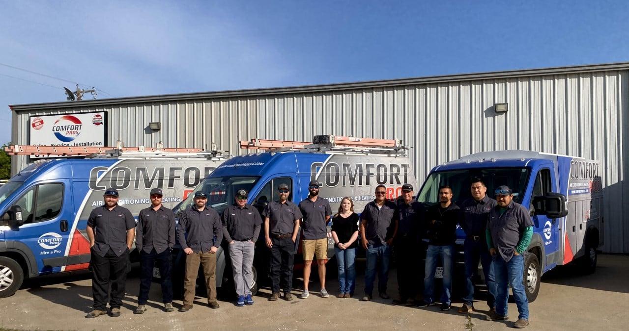 HVAC Contractor Comfort Pros employees standing together in front of the business. 